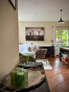 a living room with a couch and a table at Spacious 2-bed, 2-bath villa with garden and parking in Nelspruit