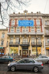 a gray car parked in front of a building at Opera Passage Hotel & Apartments in Lviv