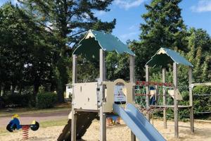 a playground with a slide in a park at Camping 3 étoiles - Piscine - eebebg in Guéméné-Penfao