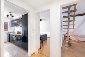 een keuken en een woonkamer met een wenteltrap bij Az-Living Heppenheim in Heppenheim an der Bergstrasse