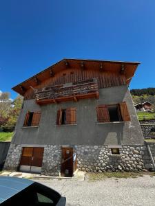 a building with wooden doors and windows on it at Chalet école des cimes in Bozel