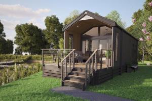 une représentation d'une minuscule maison noire sur l'herbe dans l'établissement The Hideaway Sleeps 6 at Thurston Manor Park B, à Innerwick