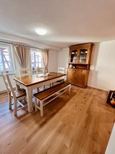 a dining room with a wooden table and chairs at Fewo Geib in Meisenheim +11 photos
