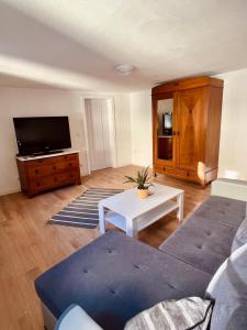 a living room with a couch and a tv at Fewo Geib in Meisenheim +11 photos
