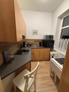 a kitchen with a sink and a counter top at FeWo JW Altentreptow in Altentreptow