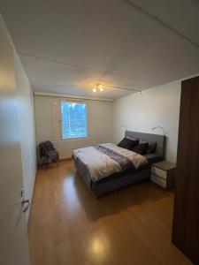a bedroom with a large bed and a window at A great apartment for daily or weekly rent 60m in Espoo