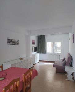 a living room with a table and a couch at Apartaments Els Avets in Pas de la Casa