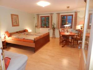 a bedroom with a bed and a table in it at Wampendobler Paradies in Egglham