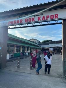 a group of people standing outside of aaza goat kipper at Homestay Abah , Kota Bharu, Kelantan in Kota Bharu