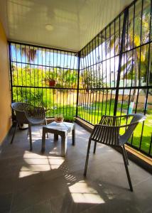 a room with two chairs and a table in front of a window at Refugio Encantador in Santo Domingo