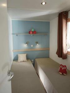 a small bedroom with a bed in a room at Camping 3 étoiles - efb0hg in Arques-la-Bataille