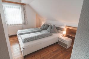 Putterer Stadl في دونيغسباشوالد: غرفة نوم بيضاء صغيرة بها سرير ونافذة