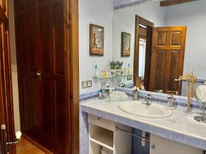 a bathroom with a sink and a mirror at El Ramiral in Bahabón +13 photos