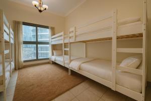 a bedroom with two bunk beds and a window at TravelTime Marina in Dubai