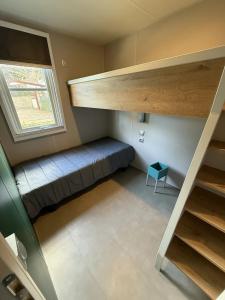 a small room with a bed and a window at Camping 4 étoiles - Piscine - ccbbecd in Le Grau-dʼAgde
