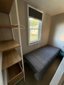 a small room with a bed and a window at Camping 4 étoiles - Piscine - ccbbecd in Le Grau-dʼAgde +106 photos