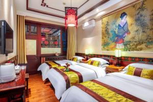 Ένα ή περισσότερα κρεβάτια σε δωμάτιο στο Pingyao Cheng Jia Hotel