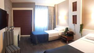 Postel nebo postele na pokoji v ubytování Dedepark Hotel