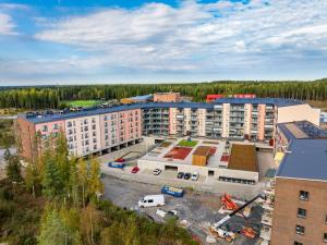 an aerial view of a building with a parking lot at Hiisi Homes Kangasala in Suorama