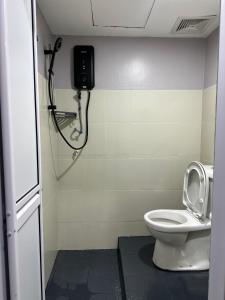 a bathroom with a toilet and a shower at Lux City Hotel in Seremban