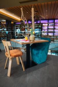 a wooden table and a chair in a restaurant at Appartements Spieljoch by Unterlercher in Fügen