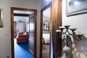a hallway with a room with a bed and a mirror at Domaine des Rochaules in Valoreille