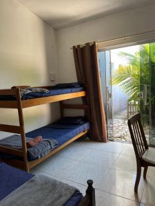 a bedroom with a bunk bed and a balcony at Renascer Suites in Búzios +19 photos
