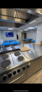 a kitchen with a stove top oven in a room at Pension Moerdijk in Moerdijk