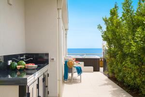 a patio with a view of the ocean from a house at Villa Hermes in Noto Marina