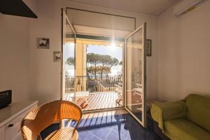 a living room with a glass door leading to a balcony at Casa D'Amato - Nel cuore di Maiori in Maiori