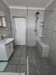 a bathroom with a shower and a sink at Coda in Umkomaas +22 photos