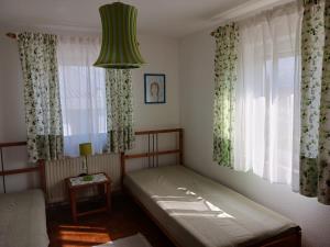a bedroom with a bed and a green lamp at Weingut Landmann Ferienwohnungen in Freiburg im Breisgau