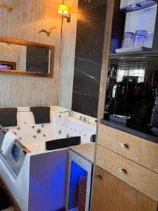 une cuisine avec une baignoire et un comptoir avec un évier dans l'établissement Mała Anglia Deluxe Rooms & SPA, à Sopot