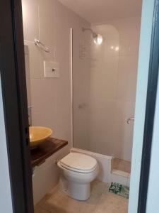 a bathroom with a toilet and a shower and a sink at 143 Boutique in Villa Gesell +21 photos