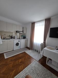 a kitchen with white cabinets and a table and a window at Studio O&A in Cristian +19 photos