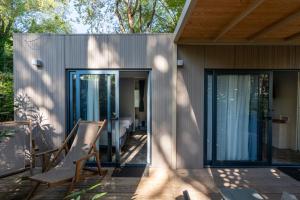 a house with sliding glass doors on a patio at Vibra Glamping in Cavallino-Treporti +30 photos