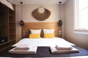 a bedroom with a bed with towels on it at Les Prairies de la Mer in Grimaud +94 photos