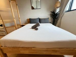 a large white bed in a room at Chambers by Lumira Haven Klcc in Kuala Lumpur