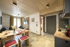 a kitchen and living room with wooden ceilings at Haus Sternenhimmel in Oberammergau +154 photos