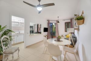 a kitchen and dining room with a table and chairs at Feel The Sun In Tenerife in Costa Del Silencio