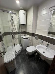 a bathroom with a shower and a toilet and a sink at Luxury South Beach Hotel in Batumi +112 photos