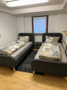 a bedroom with two beds and a window at 5 personen Monteur Ferien Wohnung in Merseburg