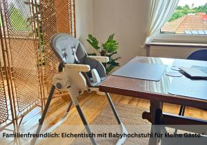 a chair sitting in front of a table at Ferienwohnungen Schwarzhof -Hanfdell in Nohfelden