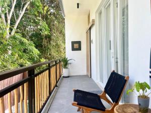 a balcony with two chairs and a table at Villa Lulu - Uluwatu Nusa Dua in Ungasan