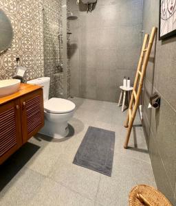 a bathroom with a toilet and a sink at Villa Lulu - Uluwatu Nusa Dua in Ungasan