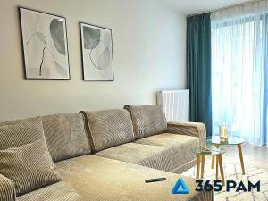 a living room with a couch and a table at 365PAM - Apartament Leaf 6-osobowy in Ustronie Morskie +26 photos