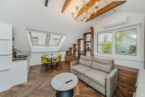 a living room with a couch and a table at Chamber Luxury House in Kaunas