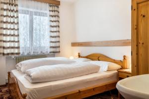 Ένα ή περισσότερα κρεβάτια σε δωμάτιο στο Appartamento Borésc