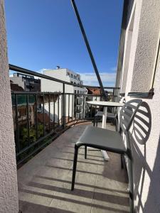 a balcony with a bench and a table on a building at Urban Nest Belgrade in Belgrade