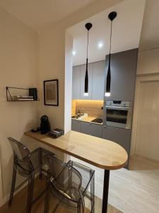 a kitchen with a wooden table and chairs in a room at Urban Nest Belgrade in Belgrade +3 photos